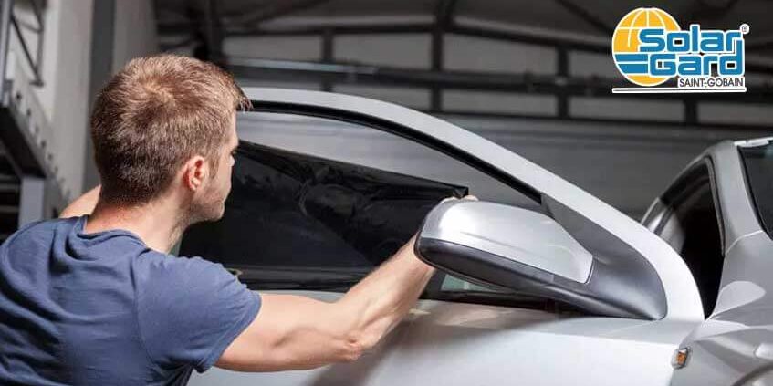 Car window being tinted by Solar Gard's professional.